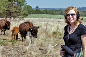 Harvest reporter Jessica Naudziunas stands in a field