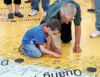 Man and child down on Big Map of Vietnam