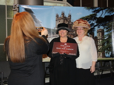 Fans pose in front of a Downton Abbey backdrop