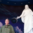 Scott Carrier poses with Jesus Christ scuplture at Temple Square's Visitor Center, Salt Lake City. Photo: Julian Cardona