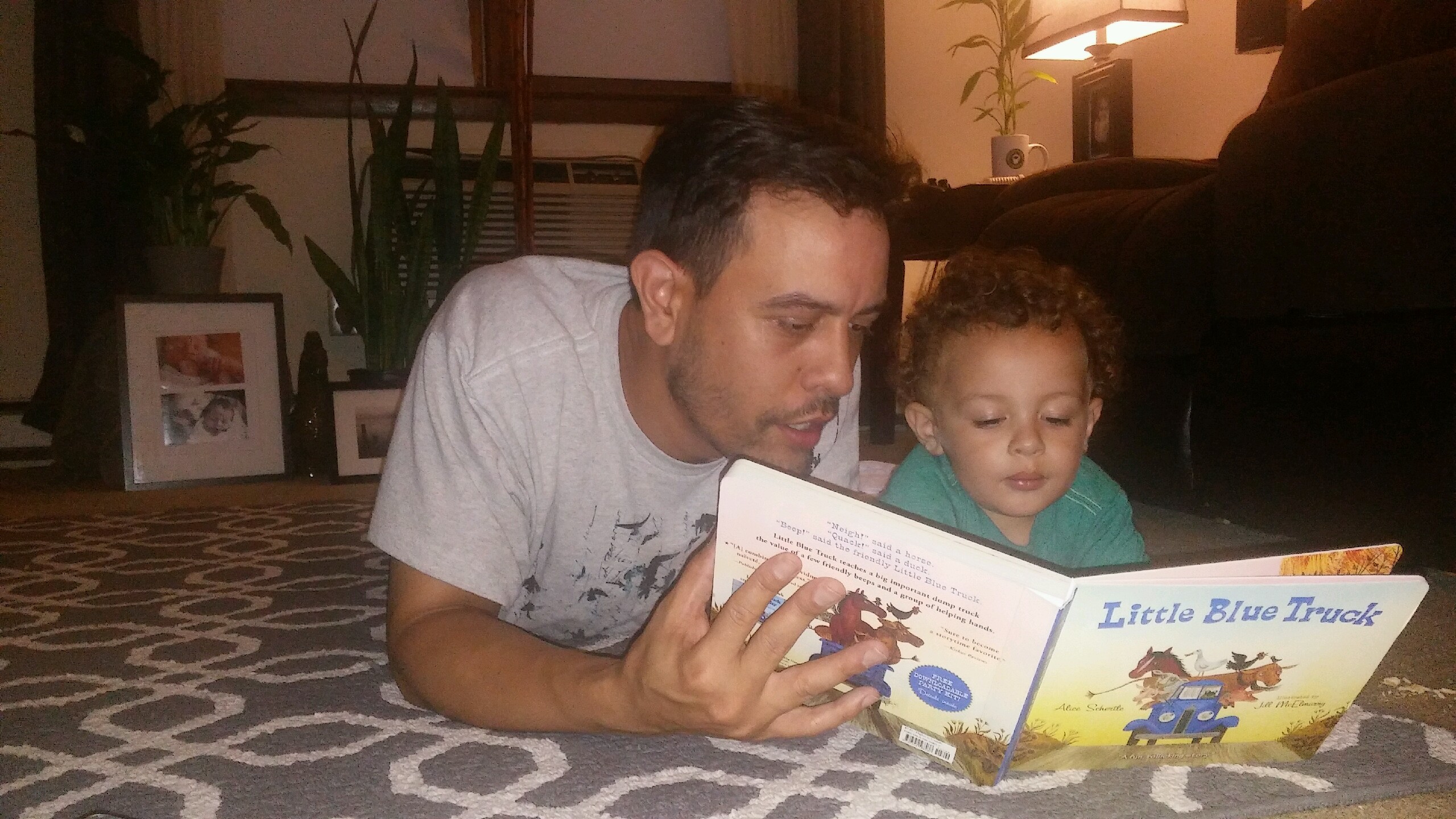 A 413 Families participant reads to his child.