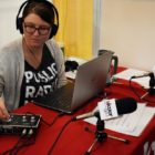 A KUER reporter helps out at a mobile sound booth at a local children’s festival.
