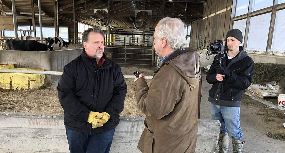 A reporter interviews a farmer for a Milwaukee PBS documentary