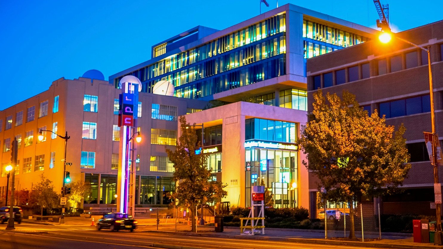 NPR headquarters in Washington, DC at night.