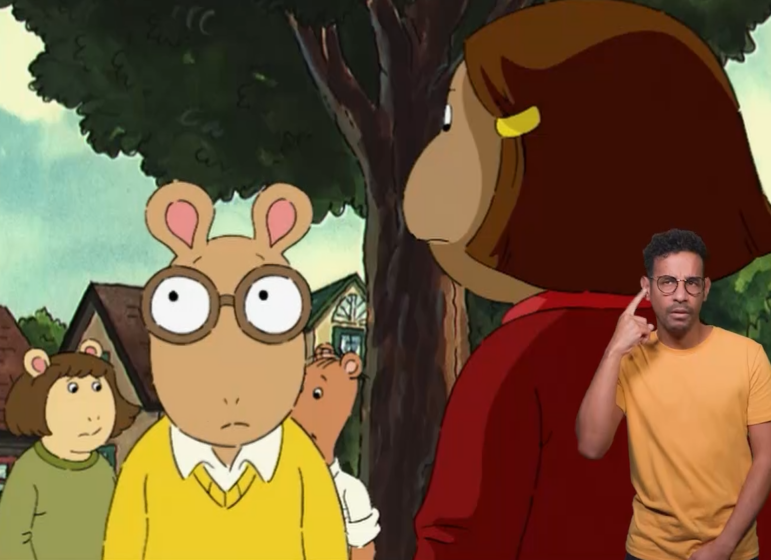 An ASL interpreter wears round glasses and a yellow shirt to show that he's representing Arthur.