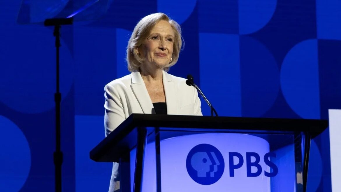 Paula Kerger, PBS President, stands at a podium wearing a white blazer at the 2024 PBS Annual Meeting in Las Vegas.