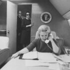 Liz Carpenter, a journalist who worked as an aide to President Johnson and Lady Bird Johnson, talks on the phone while working on Air Force One.