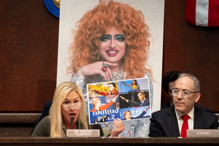 Chairman Rep. Marjorie Taylor Greene, R-Ga., speaks during the hearing in front of a photo of a drag queen. Greene displayed photos of Democrats making gestures that she said were similar to a gesture made by Elon Musk that some have construed as a Nazi salute.