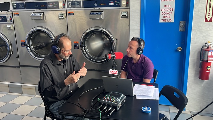 WNYC Community Partnerships editor George Bodarky talking with Tim Hunter of NYC Votes at Star Laundromat on Staten Island. (Photo: WNYC / Jodi Malarbe)
