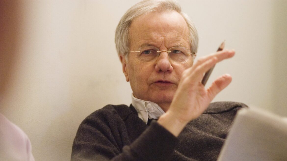 Bill Moyers gestures with his hand while talking.