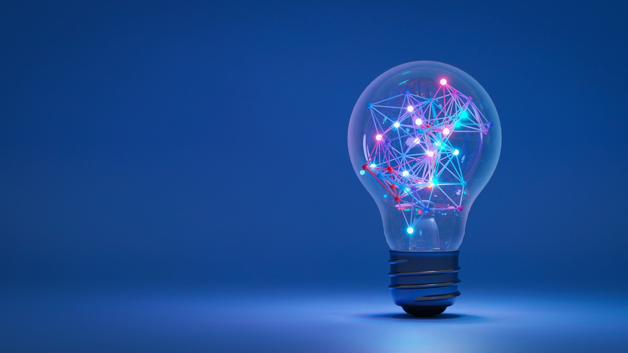 A glowing light bulb with a colorful network of interconnected nodes and lines inside, symbolizing innovation and digital connectivity, set against a blue background