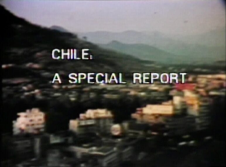 Grainy television title card with blurred city buildings and hills in the background. White block text across the center reads: “CHILE: A SPECIAL REPORT.”