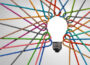 Multicolored ropes tied together in the shape of a light bulb, symbolizing collaboration and shared ideas.
