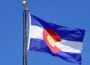 The Colorado state flag flying against a blue sky