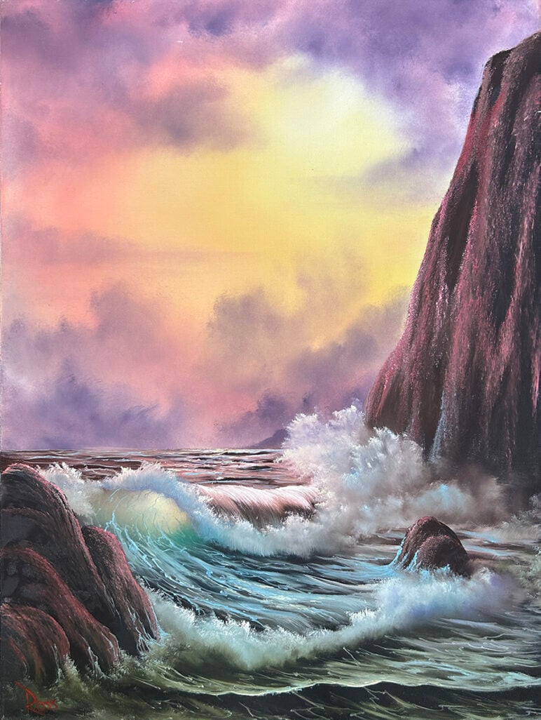 Bob Ross' painting "Cliffside." Waves crash dramatically against dark rocky cliffs under a vivid sky of purples, pinks, and yellows as the sun glows through thick clouds.