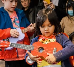 A child holds an instrument at New York Public Radio's Kids Fair in Queens in 2022.