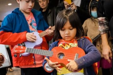 A child holds an instrument at New York Public Radio's Kids Fair in Queens in 2022.