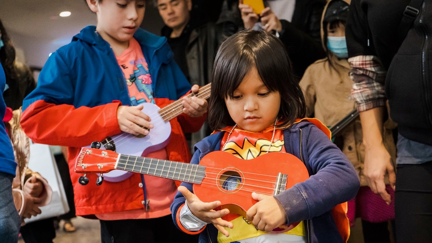 A child holds an instrument at New York Public Radio's Kids Fair in Queens in 2022.