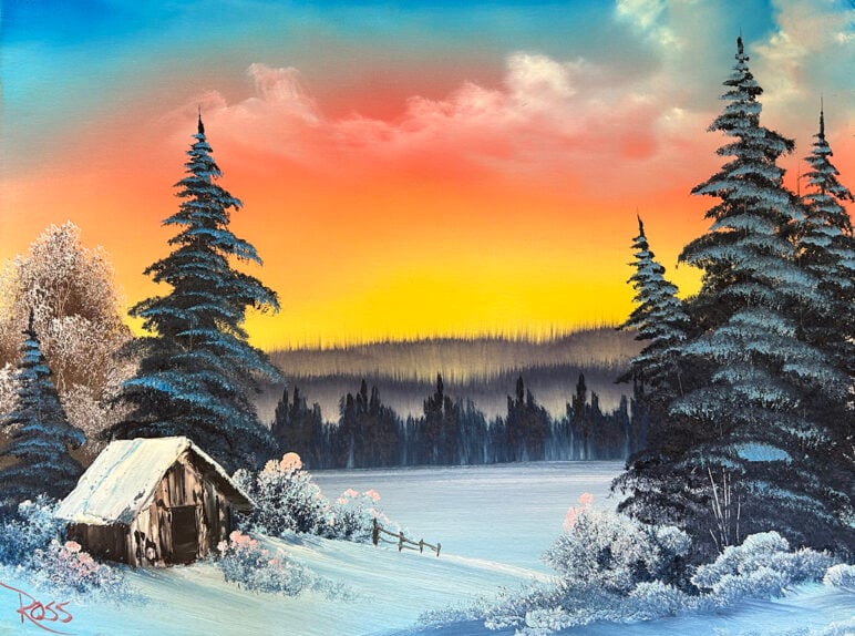 Bob Ross' painting "Winter's Peace." A snowy scene featuring a small wooden cabin near tall evergreen trees at sunset, with the sky glowing in shades of orange, yellow, and blue above a frozen landscape.
