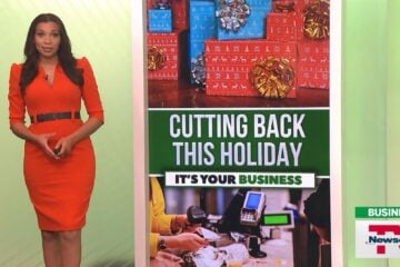 Television anchor Jasmine Anderson stands next to an image of holiday gifts and a store's checkout.