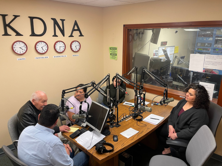 Alejandra Brito, Elizabeth Torres, Martin Yánez, Francisco Rios, and JoAnnie Trevizo sit around a table in KDNA's studios
