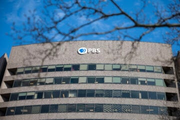 PBS' logo is featured at the top of its headquarters in Arlington, Va.