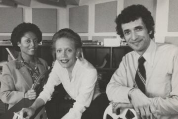 Black-and-white photo of Janet Dewart, Donna Limerick and Frank Tavares in a studio, surrounded by audio equipment.