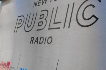 New York Public Radio's logo on a sign outside its headquarters in New York City (Headshot)