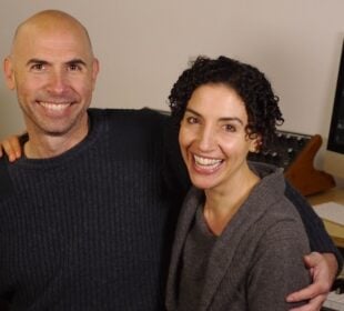 Picture of Eric Shimelonis and Rebecca Sheir embracing and smiling