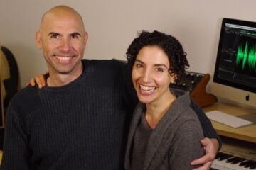 Picture of Eric Shimelonis and Rebecca Sheir embracing and smiling