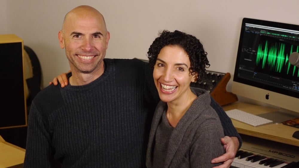 Picture of Eric Shimelonis and Rebecca Sheir embracing and smiling