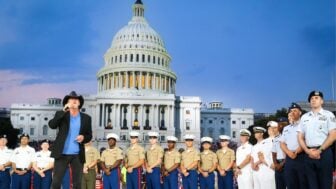 Trace Adkins performs onstage in front of the U.S. Capitol during the 2017 broadcast of "A Capitol Fourth," with members of the U.S. military standing behind him.