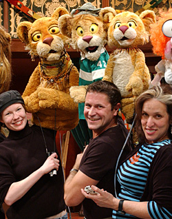 Three operate tawny child-size lion puppets