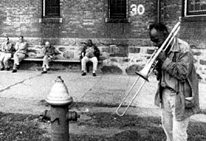 A man plays a trombone in "Titicut Follies"