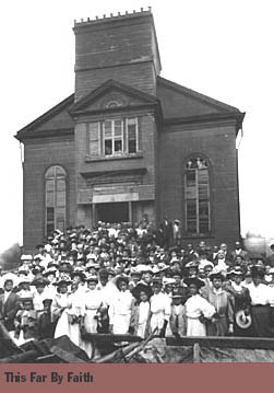 Congregation in front of its big church