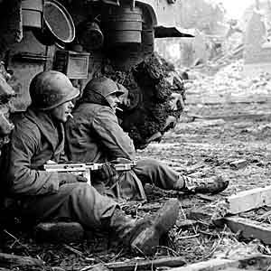 Soldiers rest beside tank