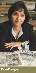 Prof. Maggie Rivas-Rodriguez with newspapers