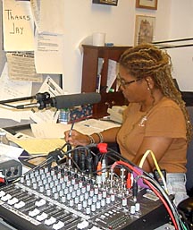 Woman working behind audio mixing board