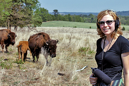 Reporter Jessica Naudzilunas on the range with buffalo
