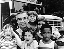 Rogers with kids in front of school bus