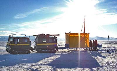 Ice-crawling vehicles in white landscape